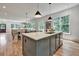 Open kitchen featuring large island with stone countertop and stainless steel appliances, open to dining and living areas at 2175 James Aly, Atlanta, GA 30345