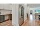 View of butler's pantry with sink and cabinets, stainless steel refrigerator, and view of open concept living area at 2175 James Aly, Atlanta, GA 30345