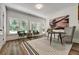 Airy office space with several windows features a black table and two comfortable chairs at 2175 James Aly, Atlanta, GA 30345