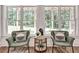 Comfortable sitting area features two chairs, an end table, and two large bright windows at 2175 James Aly, Atlanta, GA 30345