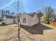 A view of the backyard featuring a concrete patio, green grass and mature trees at 2917 Yukon Nw Trl, Acworth, GA 30101