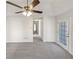 Bright bedroom with plush carpet, a ceiling fan, and a glass paneled door at 2917 Yukon Nw Trl, Acworth, GA 30101