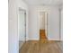 Hallway view showcasing neutral walls with a bathroom, doors, and wood flooring for a clean, modern design at 2917 Yukon Nw Trl, Acworth, GA 30101