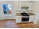 Functional kitchen with stainless steel gas range and granite countertops providing a sleek and modern cooking space at 2917 Yukon Nw Trl, Acworth, GA 30101