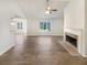Bright living room featuring a fireplace, ceiling fan, and wood flooring for a modern and cozy feel at 2917 Yukon Nw Trl, Acworth, GA 30101