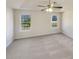 Serene main bedroom with carpet, large windows, and ceiling fan, offering comfort and relaxation at 2917 Yukon Nw Trl, Acworth, GA 30101