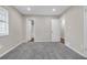 Cozy bedroom featuring soft gray carpet, neutral walls, and ample natural light at 4690 Big Valley Ct, Stone Mountain, GA 30083