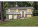 Inviting split-level home showcasing a well-kept lawn, traditional entrance, and plenty of natural light at 4690 Big Valley Ct, Stone Mountain, GA 30083