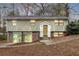 Charming home featuring stone accents and a well-maintained front yard on a wooded lot at 4690 Big Valley Ct, Stone Mountain, GA 30083