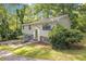 Charming split-level home surrounded by mature trees and greenery, with a well-manicured lawn at 4690 Big Valley Ct, Stone Mountain, GA 30083