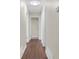 Hallway with sleek wood floors, leading to various rooms, with neutral paint at 4690 Big Valley Ct, Stone Mountain, GA 30083