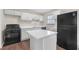 Contemporary kitchen boasts white cabinets, an island, and stainless steel appliances for a sleek, modern look at 4690 Big Valley Ct, Stone Mountain, GA 30083