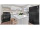 Modern kitchen with white cabinets, stainless appliances, and a central island at 4690 Big Valley Ct, Stone Mountain, GA 30083