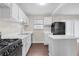 Clean kitchen featuring white cabinets, modern appliances, and plenty of natural light at 4690 Big Valley Ct, Stone Mountain, GA 30083