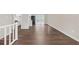 Open-concept living room seamlessly flows into the kitchen, featuring modern hardwood floors at 4690 Big Valley Ct, Stone Mountain, GA 30083
