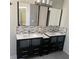 Double sink bathroom vanity with modern mirrors, fixtures, and stylish mosaic tile backsplash at 104 Oak Bend Dr, Stockbridge, GA 30281