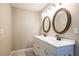 Bathroom with a double sink vanity and decorative mirrors, providing ample space and style at 1393 Vesta Ave, Atlanta, GA 30344