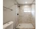 Bathroom features a marble tiled shower and a window for natural light at 1393 Vesta Ave, Atlanta, GA 30344