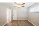 Bright bedroom with ceiling fan, wood-look floors, and neutral walls offering a versatile space at 1393 Vesta Ave, Atlanta, GA 30344