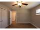 Bright bedroom with ceiling fan, wood-look floors, and neutral walls offering a versatile space at 1393 Vesta Ave, Atlanta, GA 30344