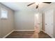 This bedroom features wood-look floors, a ceiling fan, and a double-door closet for ample storage at 1393 Vesta Ave, Atlanta, GA 30344