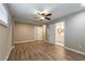 Large bedroom with wood-look floors, ceiling fan, and access to a bathroom and closet at 1393 Vesta Ave, Atlanta, GA 30344