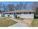 Charming single-story home with blue shutters, a blue door, and mature trees at 1393 Vesta Ave, Atlanta, GA 30344