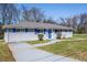 A charming single-story home with blue shutters, blue front door, and mature trees at 1393 Vesta Ave, Atlanta, GA 30344