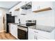 Modern kitchen featuring white cabinets, granite countertops, and stainless steel appliances at 1393 Vesta Ave, Atlanta, GA 30344