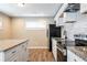 Modern kitchen featuring white cabinets, granite countertops, and stainless steel appliances at 1393 Vesta Ave, Atlanta, GA 30344