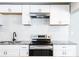 Bright kitchen featuring white cabinets, subway tile backsplash, and stainless steel appliances at 1393 Vesta Ave, Atlanta, GA 30344