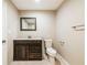 Bathroom features a dark vanity with a white countertop and stylish mirror and modern fixtures at 1780 Brewer Sw Blvd, Atlanta, GA 30310