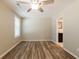 Light-filled bedroom featuring a ceiling fan, fresh paint, new windows and modern wood-look floors at 1780 Brewer Sw Blvd, Atlanta, GA 30310