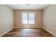Empty bedroom features neutral walls, wood-look floors, and a large window at 1780 Brewer Sw Blvd, Atlanta, GA 30310