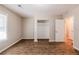 Bedroom featuring wood flooring, a window, closet, and door leading to hallway at 1780 Brewer Sw Blvd, Atlanta, GA 30310