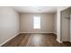 Bedroom featuring wood flooring, window, and closet at 1780 Brewer Sw Blvd, Atlanta, GA 30310