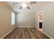Light-filled bedroom featuring a ceiling fan, fresh paint, new windows and modern wood-look floors at 1780 Brewer Sw Blvd, Atlanta, GA 30310