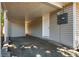 View of the carport featuring a concrete floor, neutral colored siding, and a white door at 1780 Brewer Sw Blvd, Atlanta, GA 30310