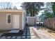 Exterior view of the home featuring neutral siding, a stepping stone path, and a small carport at 1780 Brewer Sw Blvd, Atlanta, GA 30310