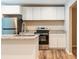 Bright kitchen features white cabinets, stainless steel appliances, granite counters, and an island with a sink at 1780 Brewer Sw Blvd, Atlanta, GA 30310
