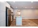 Bright kitchen features white cabinets, stainless steel appliances, granite counters, and an island with a sink at 1780 Brewer Sw Blvd, Atlanta, GA 30310