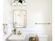 Bright bathroom with a modern vanity, gold fixtures, and a classic white toilet at 206 Reinhardt St Se, Atlanta, GA 30312