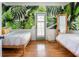 Bright bedroom with nature wallpaper, natural light, and hardwood floors at 206 Reinhardt St Se, Atlanta, GA 30312