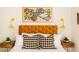 Cozy bedroom featuring a yellow upholstered headboard, bedside tables, and stylish accent lighting at 206 Reinhardt St Se, Atlanta, GA 30312