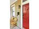 Charming front porch with a red door, rattan chairs, and classic exterior lighting at 206 Reinhardt St Se, Atlanta, GA 30312