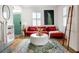 Inviting living room with stylish decor, warm wood floors, and a comfortable red velvet sectional sofa at 206 Reinhardt St Se, Atlanta, GA 30312
