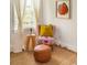 Sunlit living room featuring patterned chair, a jute rug, and draped windows at 206 Reinhardt St Se, Atlanta, GA 30312