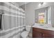 Bathroom featuring a shower-tub combo with a shower curtain, and a vanity with dark-stained cabinets at 2554 Crescent Park Ct # 6, Atlanta, GA 30339