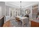 Bright dining room with hardwood floors, elegant chandelier, and French doors leading to outdoor space at 2554 Crescent Park Ct # 6, Atlanta, GA 30339