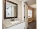 Bathroom vanity featuring a granite countertop and view of a tiled shower at 264 Silver Springs Sw Cir, Atlanta, GA 30310